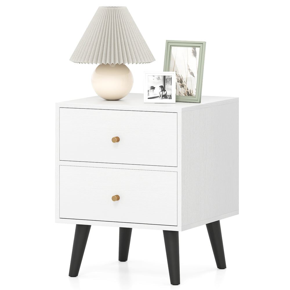 Mid Century Modern bedside table in white with golden knobs, featuring two drawers and tapered black legs for stylish.