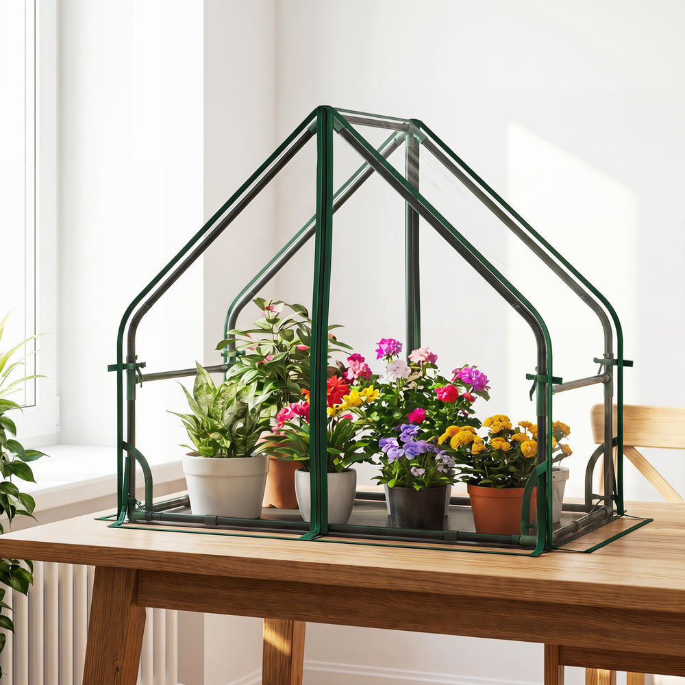 Mini greenhouse with a sturdy metal frame, featuring colorful plants and a waterproof bottom mat for indoor or outdoor.