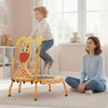 Toddler jumping on a mini trampoline with foam padded handle, featuring a giraffe design for safe play and balance.