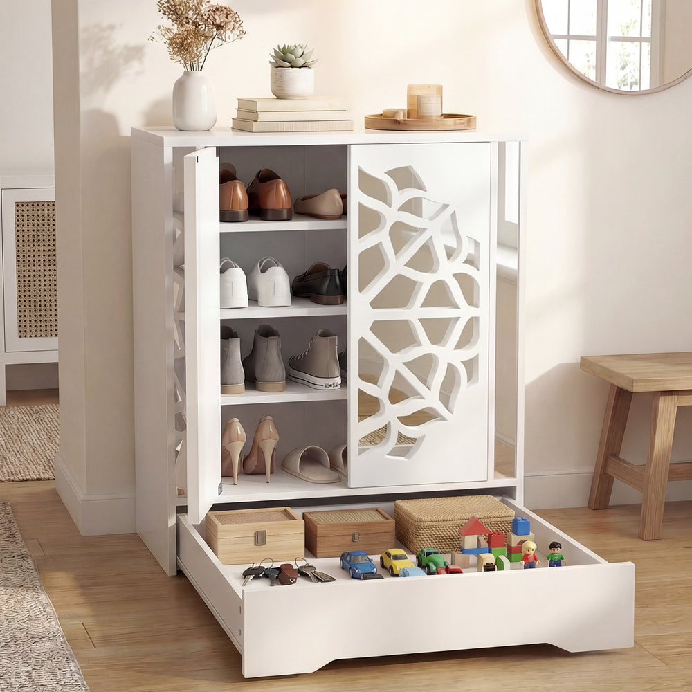White mirrored shoe cabinet with hollow-carved doors, 4 tiers for shoe storage, and a large bottom drawer for.
