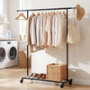 Mobile garment rack with extendable rods and lower bars for bins, perfect for organizing clothes in dressing areas.