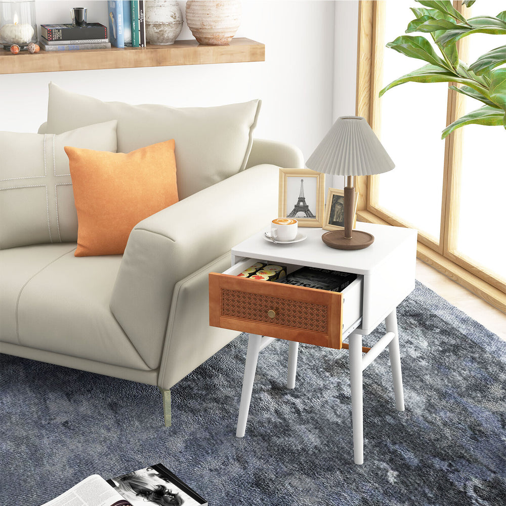 Modern bedside table with solid wood legs, rattan front panel, and large drawer, perfect for bedroom or living room use.
