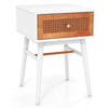 Modern bedside table with solid wood legs, rattan front panel, and large drawer, ideal for bedroom or living room use.
