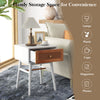 Modern bedside table with solid wood legs, rattan drawer front, and wide tabletop for lamps and plants in white finish.