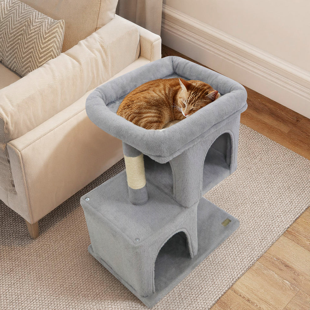 Gray modern cat tree featuring a cozy upholstered perch and two spacious condos, ideal for small apartments.