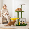 Multi-level green cat tree features cozy perches, a soccer field, and scratching posts for indoor kittens' play and rest.
