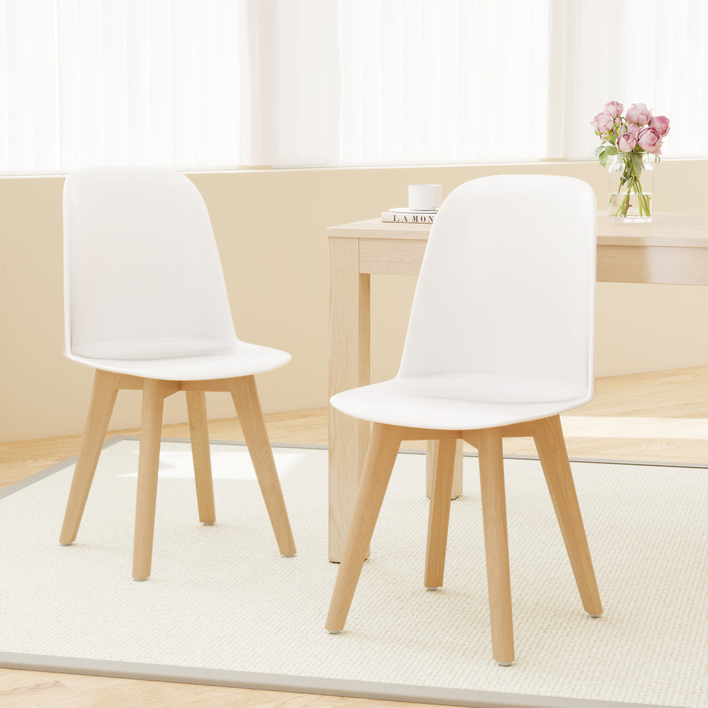 Set of 2 modern dining chairs with white PP seats and solid beech wood legs, perfect for dining or living spaces.