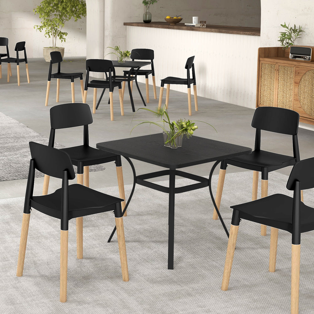 Set of four black modern dining side chairs with ergonomic backrests and beech legs, perfect for dining rooms and cafes.