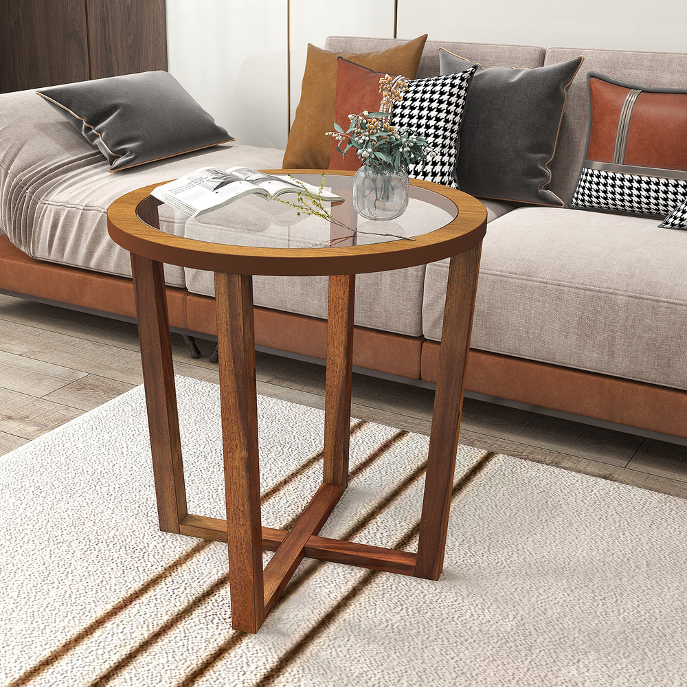 Modern round end table with solid acacia wood legs and transparent tempered glass top, perfect for decorative items.