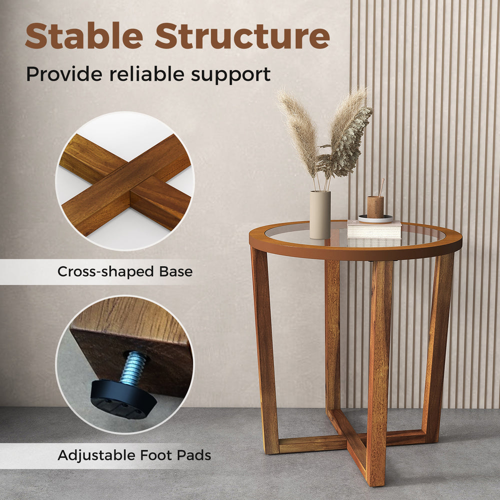 Modern round end table with transparent tempered glass top and solid acacia wood legs, featuring adjustable foot pads.