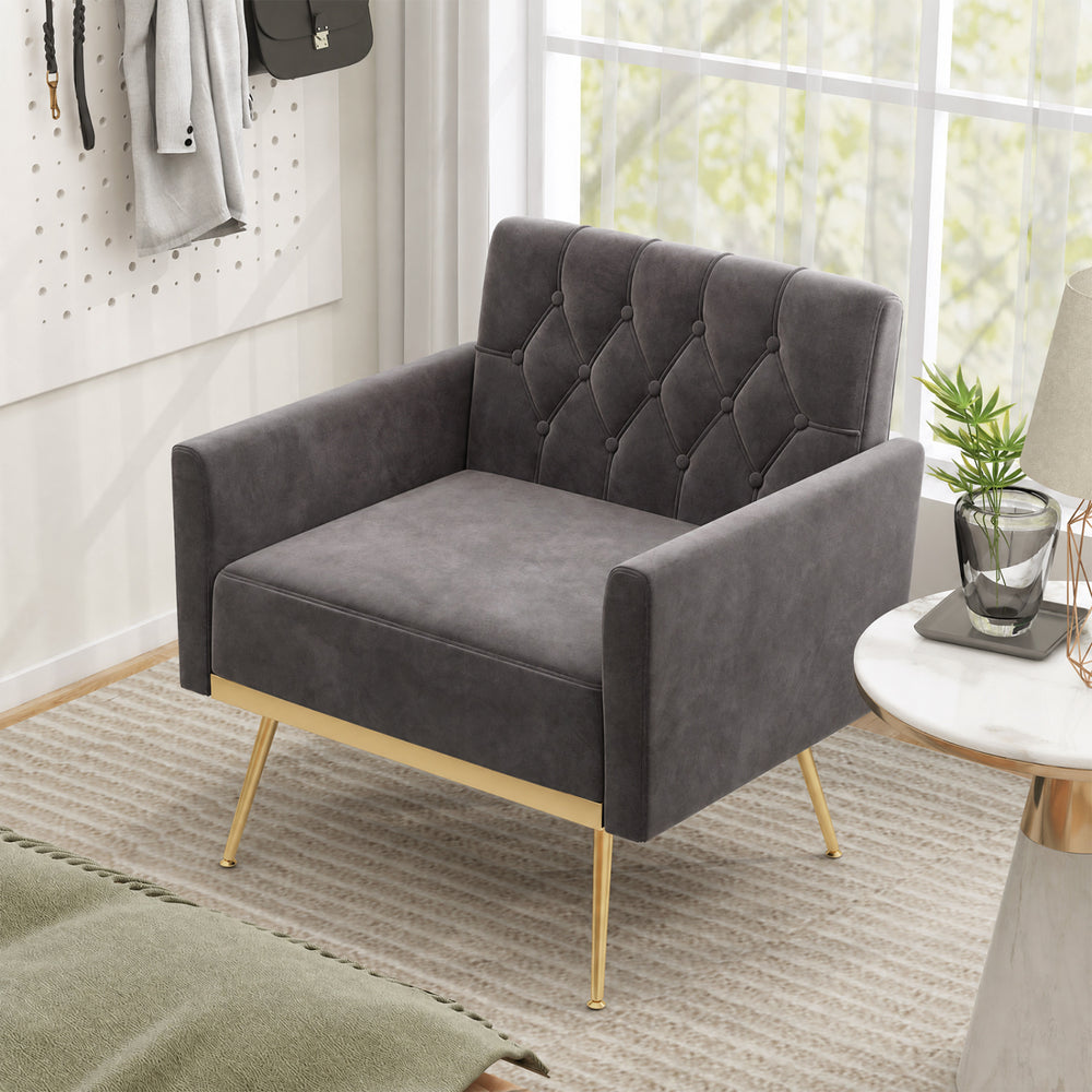 Gray velvet upholstered accent chair with button-tufted back and gold metal legs, perfect for living rooms or offices.