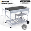 Movable grill table with spacious black tabletop, stainless steel condiment caddies, and wheels for easy outdoor use.