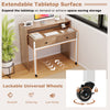 Extendable computer desk in natural finish with pull-out secondary desk and lockable wheels, perfect for space-saving.