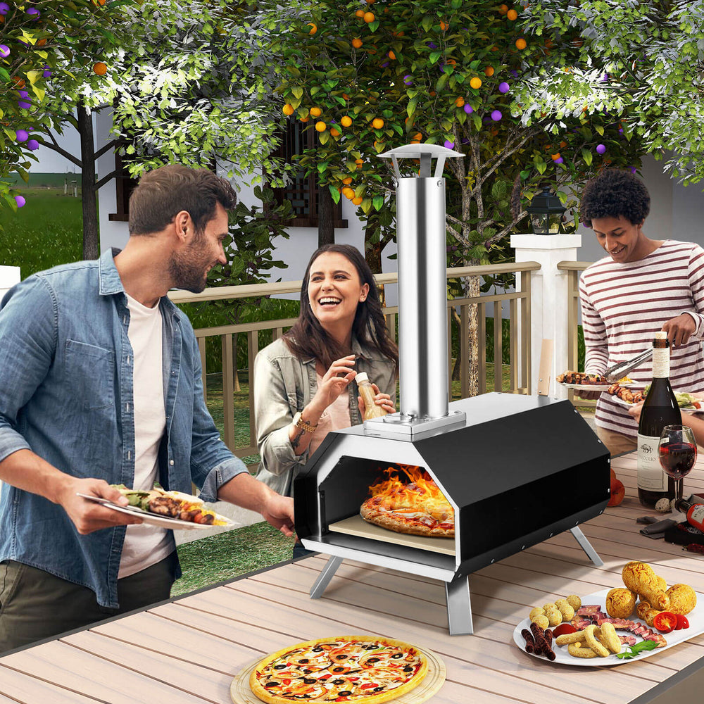 Outdoor pizza oven with foldable legs, cooking a 12" pizza, ideal for camping and outdoor gatherings.