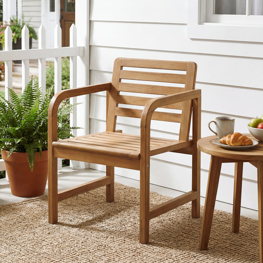 Natural wood patio armchair with slatted seat and slanted back, perfect for outdoor relaxation on the porch or balcony.