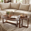 Nesting coffee table set of 2 in walnut with solid rubberwood legs, featuring oval and round tops for versatile use.