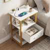 Nightstand with charging station in white and gold, featuring open shelves and an adjustable fabric drawer for.