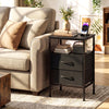 Black nightstand with charging station, featuring a wide tabletop and convenient fabric drawers, perfect for bedside.
