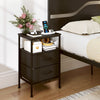 Modern black nightstand with charging station, two fabric drawers, and open compartment for bedside storage and.