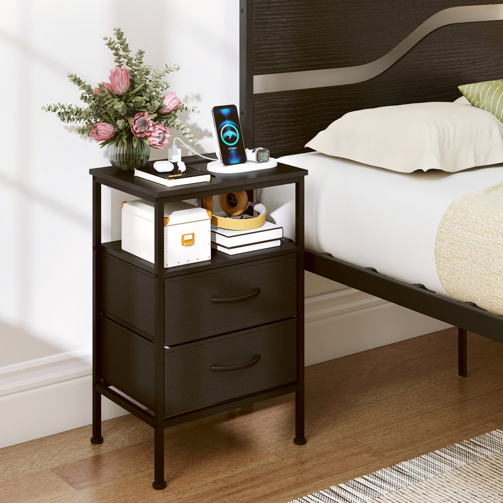Modern black nightstand with charging station, two fabric drawers, and open compartment for bedside storage and.