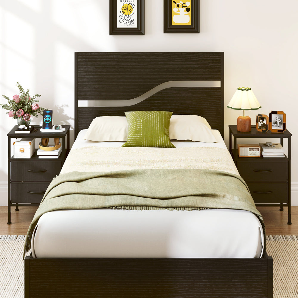 Modern black nightstand with charging station, two fabric drawers, and a stylish wood-like surface for versatile use.