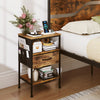 Rustic brown nightstand with charging station, fabric drawer, and open compartment for versatile bedside storage.