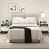 Mid-century modern nightstand in white with 3D wavy pattern, open shelf, and spacious drawer for stylish storage.