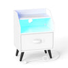 Nightstand in white with LED lights, fabric drawer, open storage shelf, and built-in charging station for versatile use.