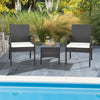 Two patio wicker dining armchairs with soft cushions and a side table, perfect for poolside relaxation.