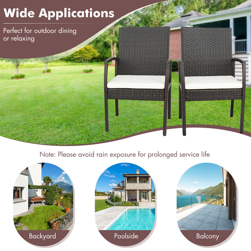 Set of two patio wicker dining armchairs with soft cushions, perfect for backyard or poolside relaxation.