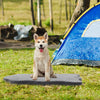 Orthopedic dog bed in gray with memory foam support, ideal for large dogs, placed outdoors near a tent.