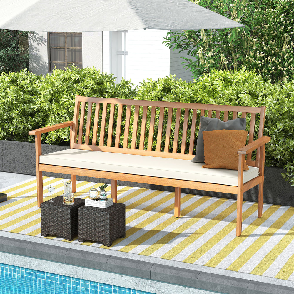 Outdoor 3-seat wood bench in acacia with soft cushion, perfect for garden or backyard relaxation by the pool.