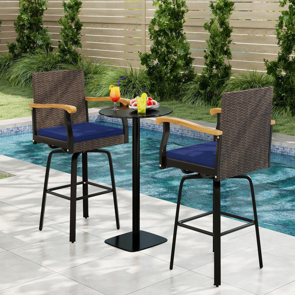 Outdoor 360° swivel bar stools with navy cushions and acacia wood armrests, perfect for poolside relaxation.