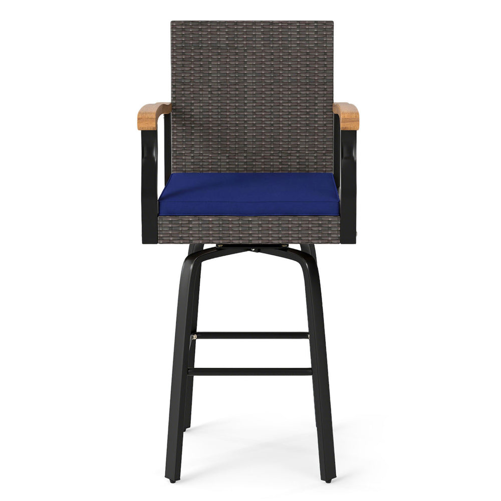 Outdoor 360° swivel bar stool features brown PE rattan, navy cushion, and acacia wood armrests for backyard comfort.