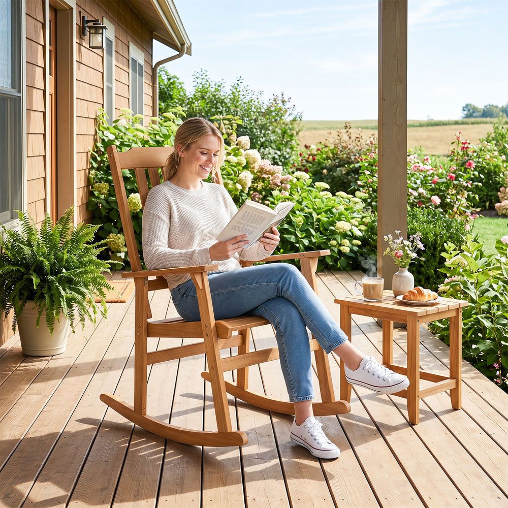 Acacia wood rocking chair with high back and armrests, perfect for outdoor relaxation on patios or porches.