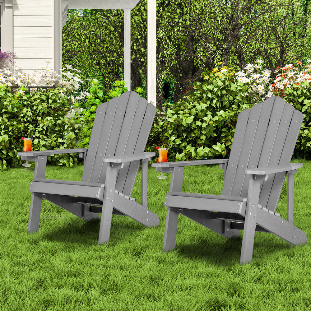 Gray weather-resistant HIPS outdoor Adirondack chairs with cup holders, perfect for garden or patio relaxation.