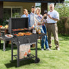 Outdoor BBQ charcoal grill with foldable side tables and wheels, perfect for large gatherings and easy grilling.