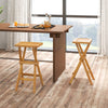 Set of 2 folding outdoor bar stools with ergonomic teak wood seats and stable x-shaped frames for easy storage.