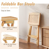 Folding teak wood bar stool with ergonomic saddle seat and x-shaped frame, ideal for outdoor storage and comfort.