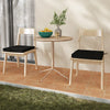 Black outdoor chair cushion set of 2, made of waterproof olefin fabric, shown on dining chairs for added comfort.