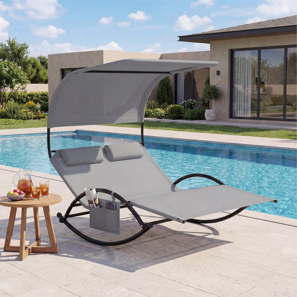 Gray outdoor dual rocker sunbed with large canopy and ergonomic design, ideal for relaxing by the pool or in the.