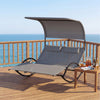 Gray outdoor dual rocker sunbed with canopy and detachable headrests, perfect for poolside relaxation.
