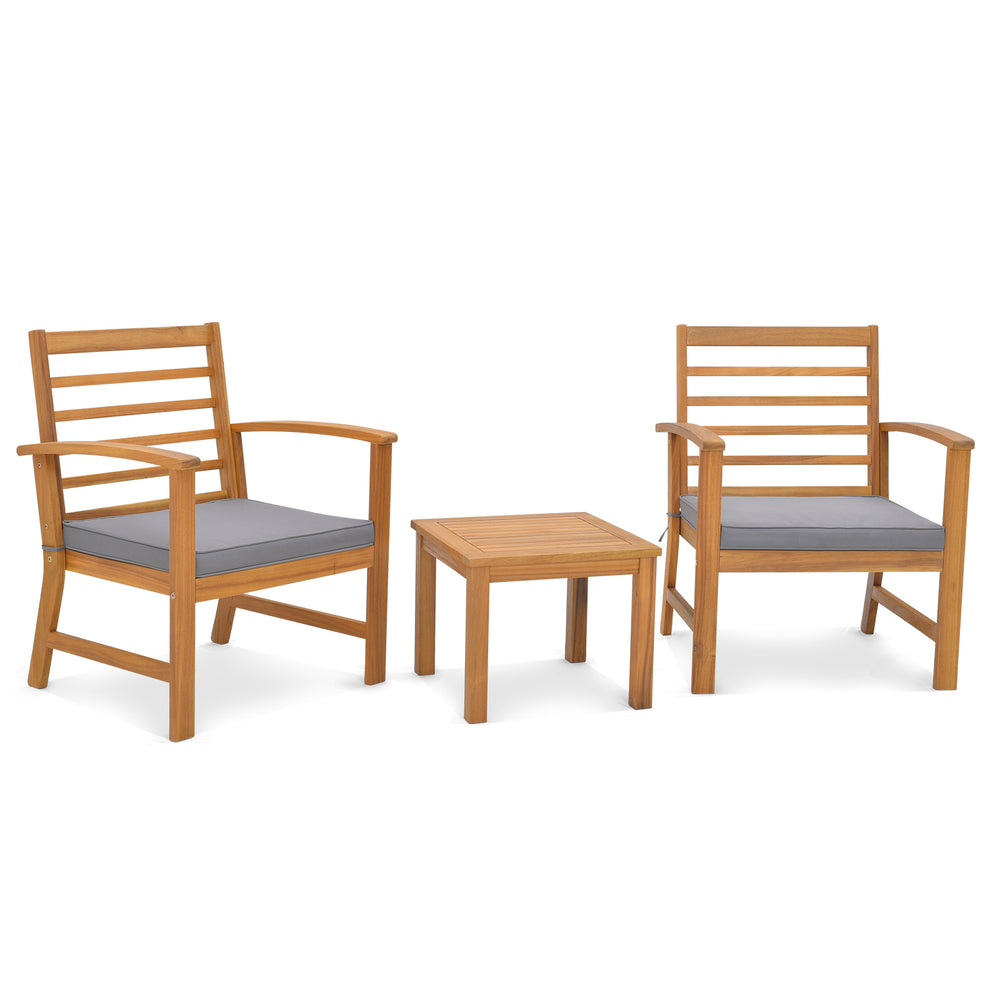 Two acacia wood chairs with gray cushions and a matching table, perfect for outdoor relaxation in your backyard.