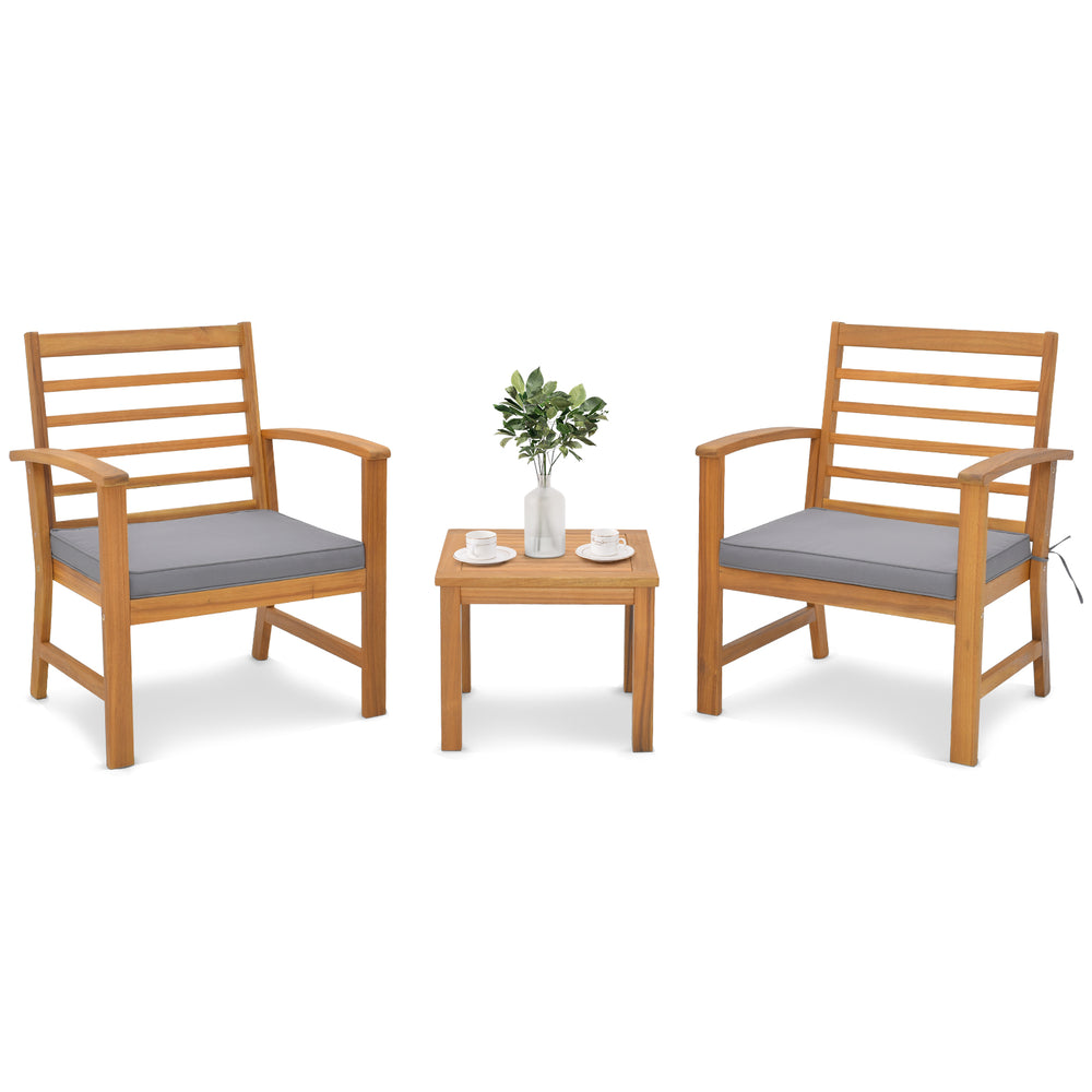 Two acacia wood chairs with gray cushions and a matching table, perfect for outdoor relaxation in your backyard or.