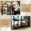 Outdoor grill cart with stainless steel tabletops, multiple storage shelves, and a central grill pot station for outdoor cooking.
