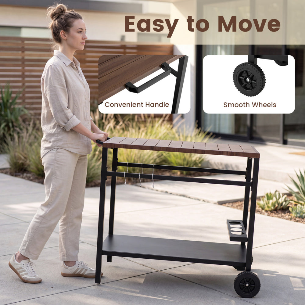 Outdoor grill cart with a stainless top, spice rack, and hooks, designed for easy movement and organization in the patio.