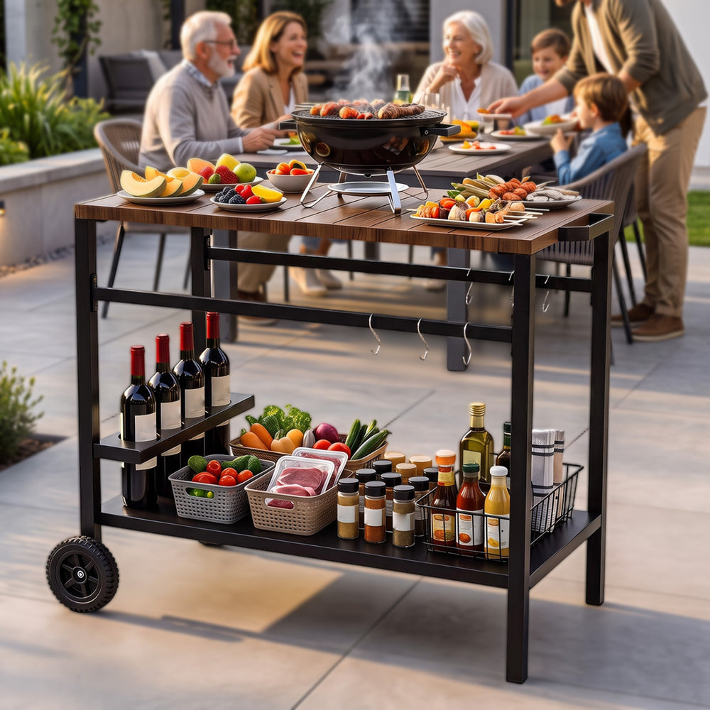 Outdoor grill cart with stainless top, spice rack, and hooks, ideal for organizing patio cooking and gatherings.