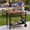 Outdoor grill cart with stainless top, spice rack, and hooks, ideal for efficient outdoor cooking and gatherings.