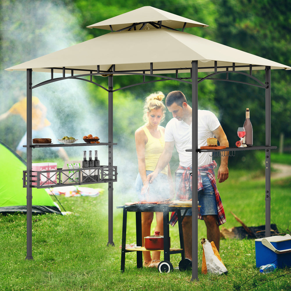 Couple grilling under the 8 x 5 feet outdoor gazebo with beige canopy, showcasing its spacious design and side shelves.