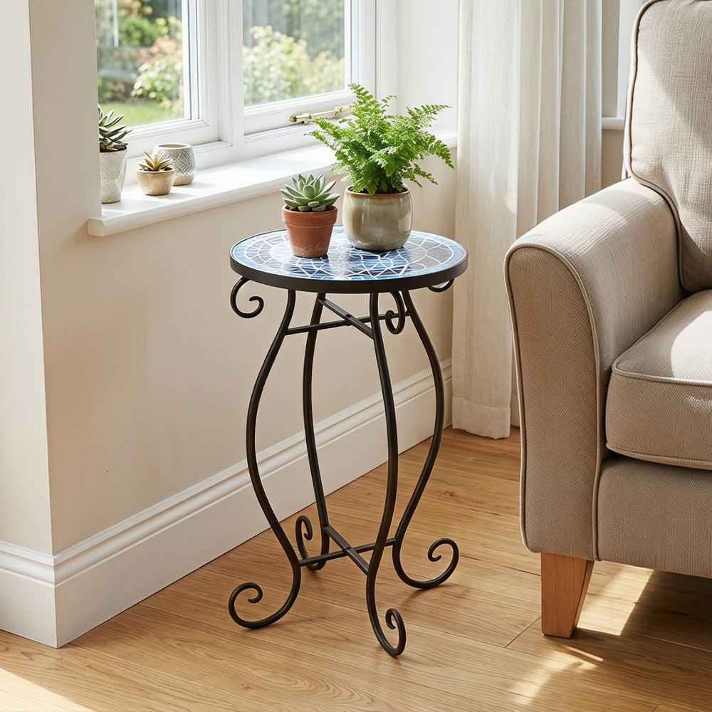 Round cobalt blue mosaic accent table with black steel frame, perfect for indoor or outdoor plant display.